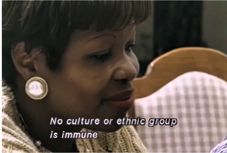 A close-up shot of a woman with short brown hair, looking to the side with a thoughtful expression. Text at the bottom reads, 'No culture or ethnic group is immune'.